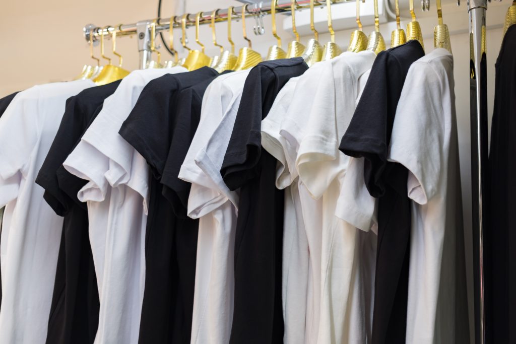 black and white t shirts on hang for sale in shop